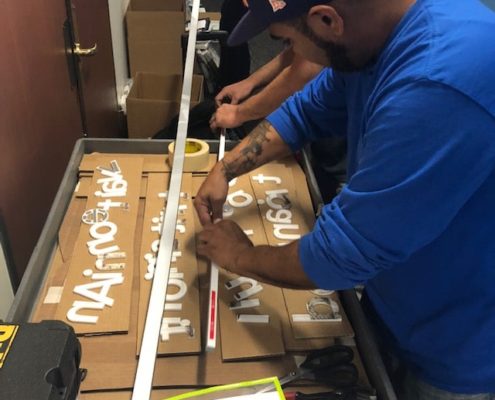 Install crew prepping dimensional letters Laser cut acrylic letters